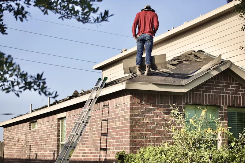 Professional roofer working on a residential roof in North Oakwood